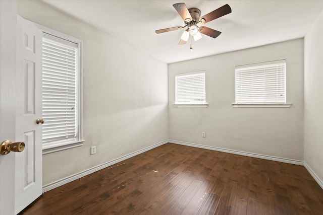 empty room with ceiling fan and dark hardwood / wood-style floors