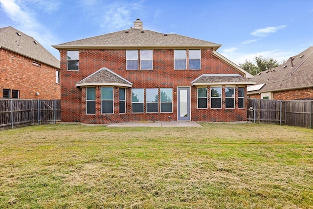 back of house featuring brick siding, a chimney, a patio area, and a fenced backyard