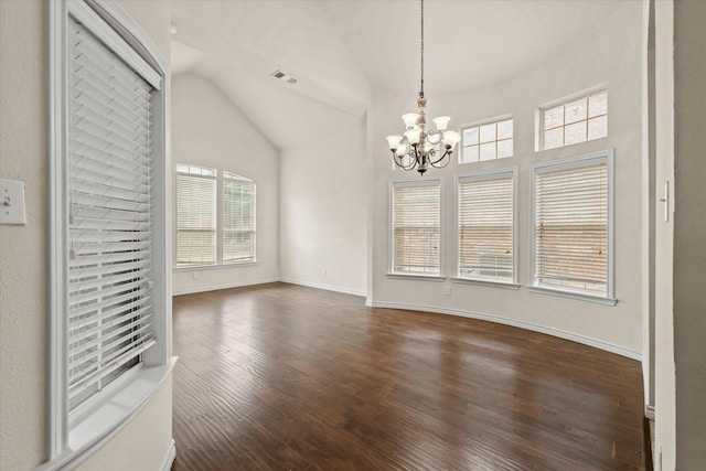 interior space with baseboards, visible vents, lofted ceiling, dark wood-type flooring, and an inviting chandelier