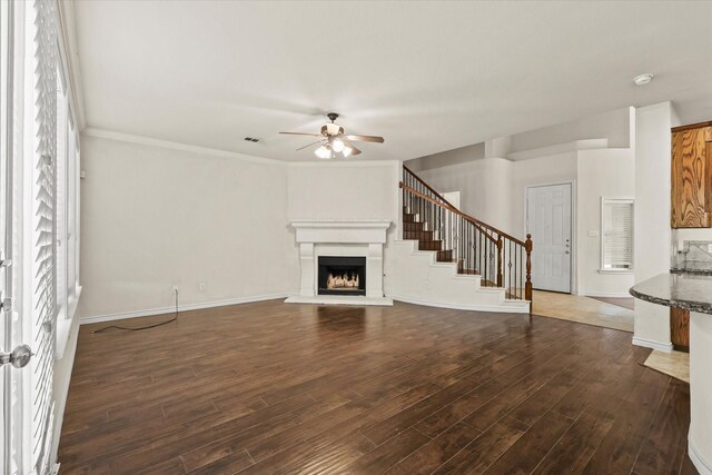 unfurnished living room with ceiling fan, crown molding, and hardwood / wood-style floors