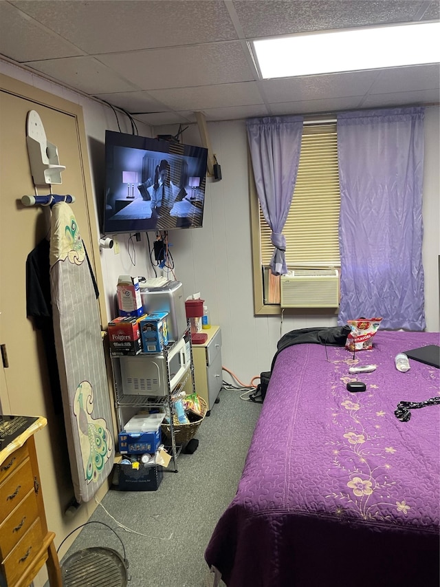 bedroom featuring cooling unit, a paneled ceiling, and carpet floors