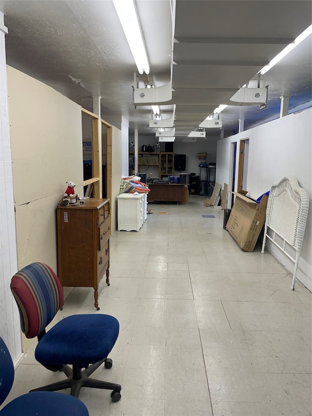 basement featuring a textured ceiling