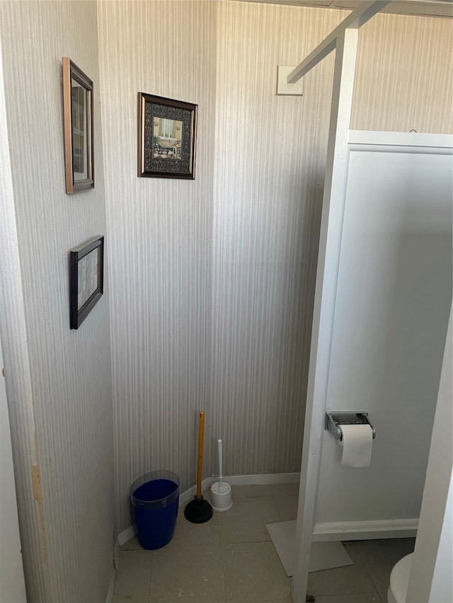 bathroom with tile patterned flooring and toilet