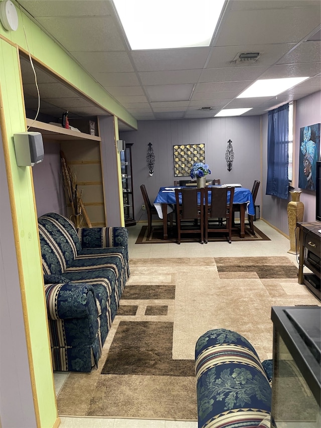 living room featuring a drop ceiling