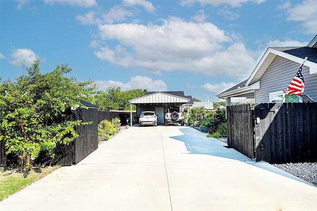 exterior space with concrete driveway and fence