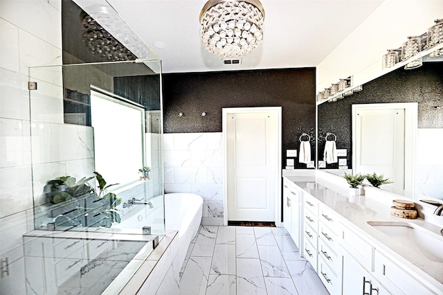 bathroom featuring a sink, visible vents, marble finish floor, a tub, and double vanity