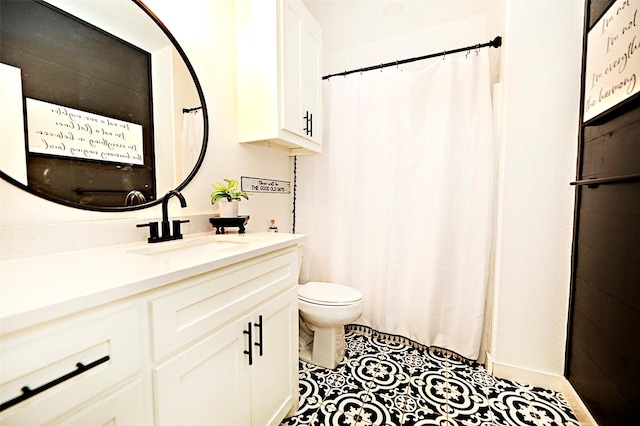 full bath with vanity, toilet, and tile patterned floors