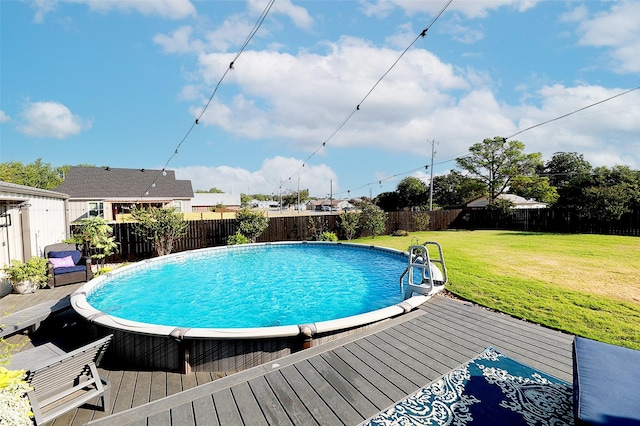 view of pool featuring a fenced backyard, a fenced in pool, a deck, and a lawn