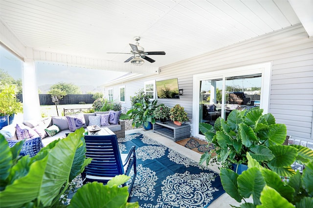 view of patio featuring an outdoor living space, fence, and a ceiling fan