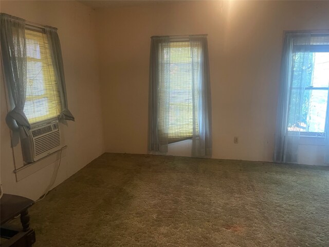 spare room with cooling unit and carpet floors