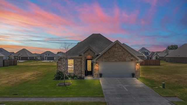 view of front of home featuring a yard and a garage