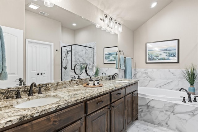 bathroom featuring visible vents, marble finish floor, a stall shower, and a sink