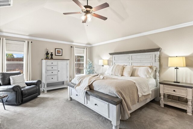 carpeted bedroom featuring ornamental molding, lofted ceiling, and ceiling fan