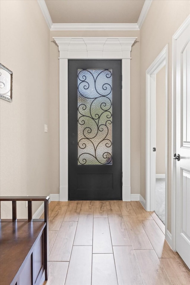 entryway featuring crown molding, baseboards, and wood tiled floor