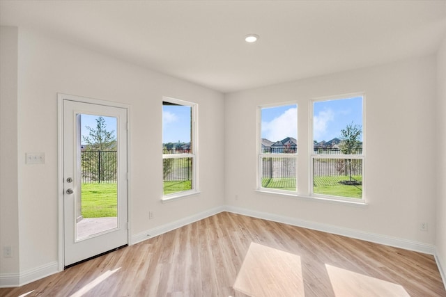 unfurnished room with light hardwood / wood-style floors