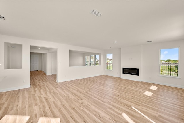 unfurnished living room with light hardwood / wood-style flooring