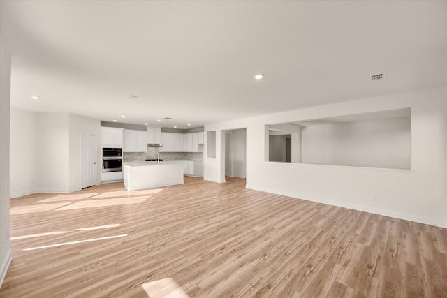 unfurnished living room featuring light hardwood / wood-style flooring