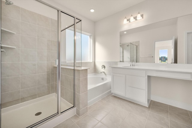 bathroom with separate shower and tub, plenty of natural light, vanity, and tile patterned flooring