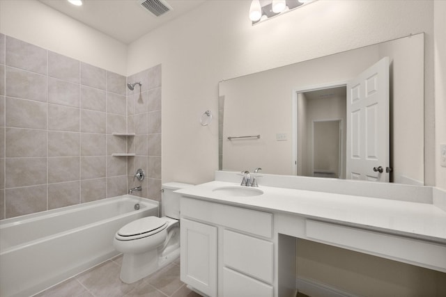 full bathroom featuring tile patterned floors, vanity, tiled shower / bath combo, and toilet