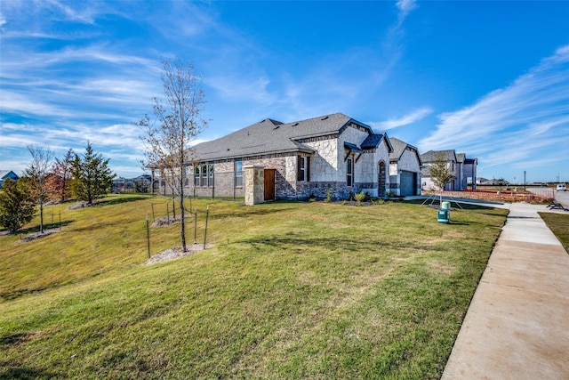 view of front facade with a front yard and a garage