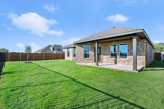 rear view of house featuring a patio and a lawn