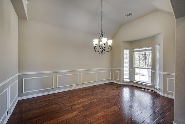 unfurnished room featuring hardwood / wood-style floors, vaulted ceiling, and an inviting chandelier