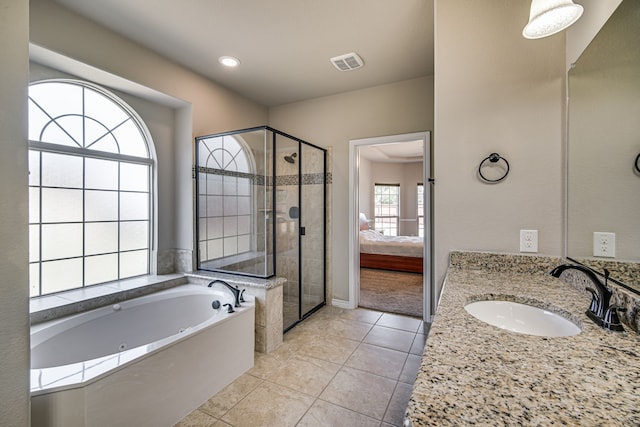 bathroom with tile patterned flooring, plus walk in shower, and vanity