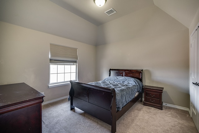 bedroom featuring vaulted ceiling and light carpet