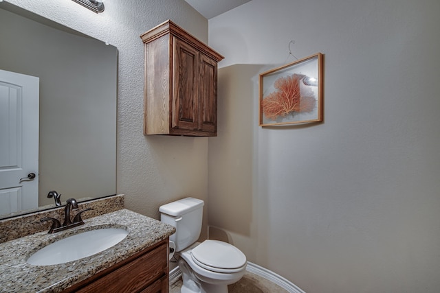 bathroom with toilet and vanity