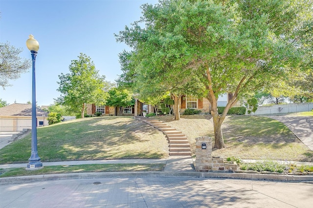 obstructed view of property featuring a front yard