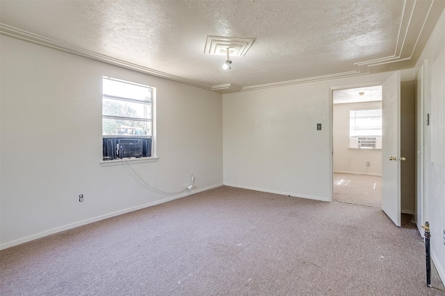 empty room featuring cooling unit, light colored carpet, a textured ceiling, and a wealth of natural light