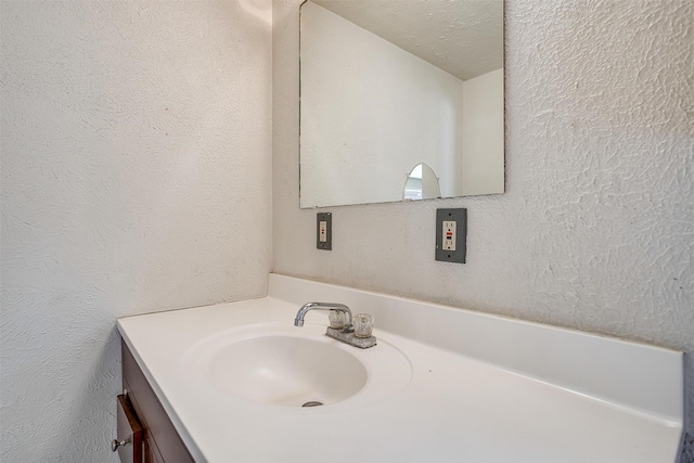 bathroom with vanity and a textured ceiling