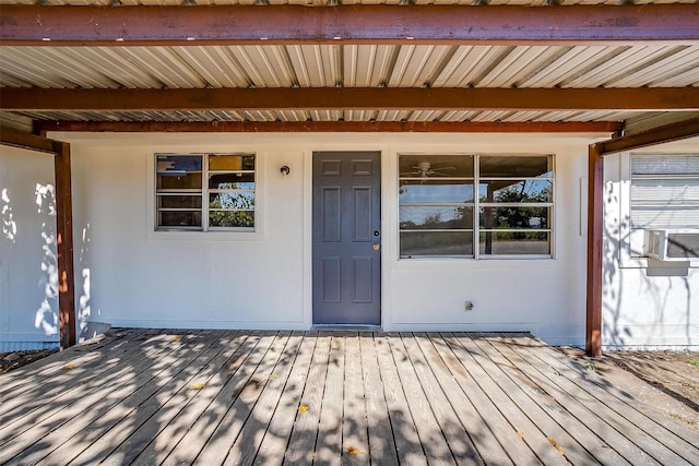 doorway to property with a wooden deck and cooling unit