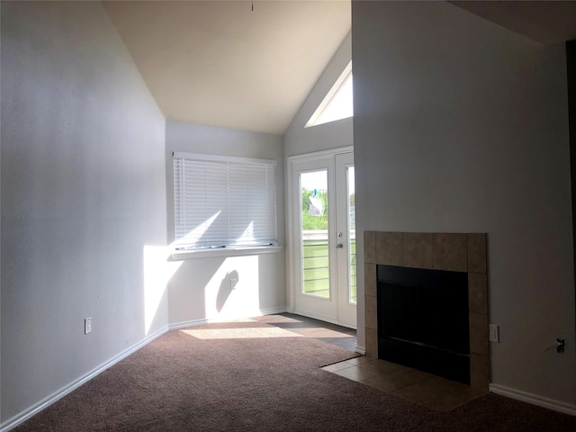 unfurnished living room with a fireplace, high vaulted ceiling, and light colored carpet