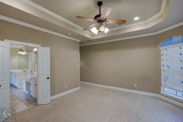 unfurnished bedroom with ceiling fan, a raised ceiling, and crown molding