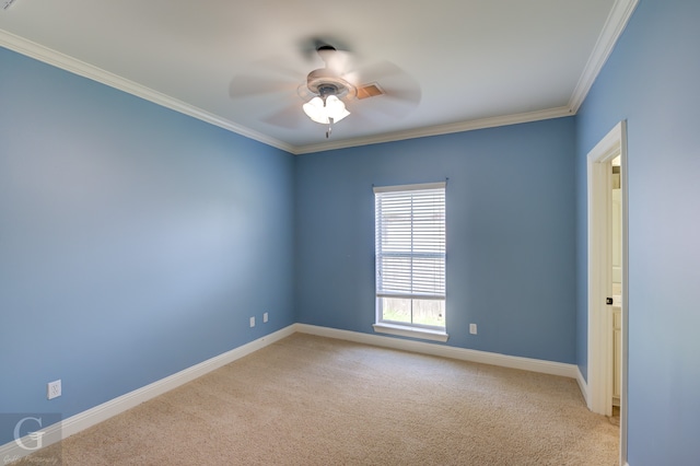 empty room featuring carpet floors, ornamental molding, and ceiling fan