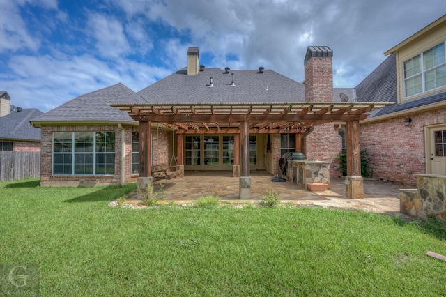 rear view of house featuring a lawn, a pergola, and a patio area