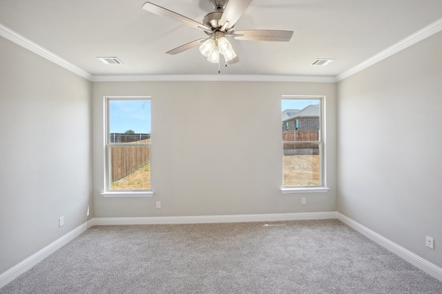 unfurnished room with a healthy amount of sunlight, crown molding, and carpet