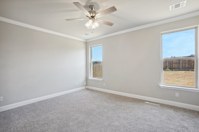 carpeted spare room featuring crown molding and ceiling fan