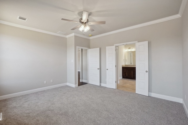 unfurnished bedroom featuring ornamental molding, light colored carpet, connected bathroom, and ceiling fan