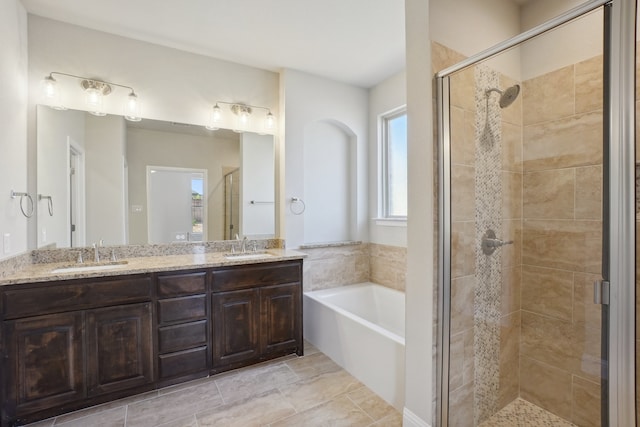 bathroom featuring tile patterned flooring, vanity, and shower with separate bathtub