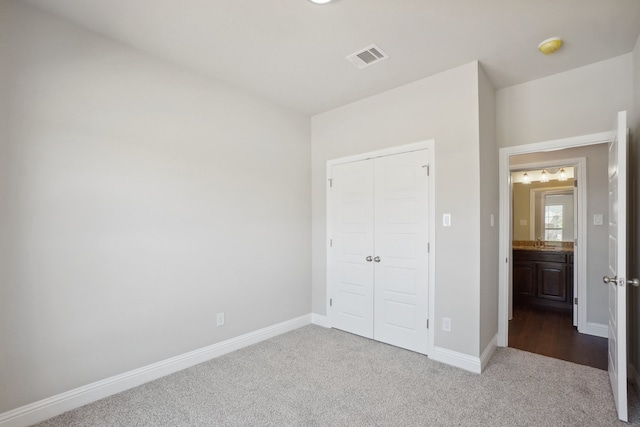 unfurnished bedroom with a closet and carpet