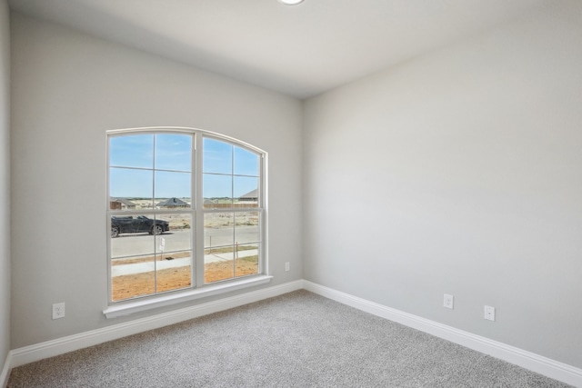 empty room with plenty of natural light and carpet floors