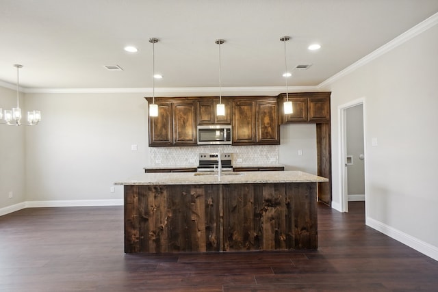 kitchen with an island with sink, light stone countertops, dark wood-type flooring, and stainless steel appliances