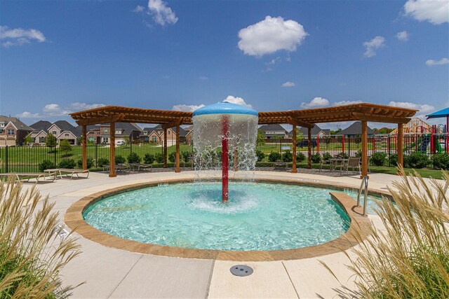 view of pool with a pergola and pool water feature