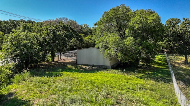 view of outbuilding featuring a lawn