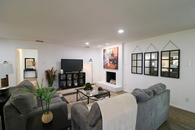 living room with a fireplace and hardwood / wood-style floors