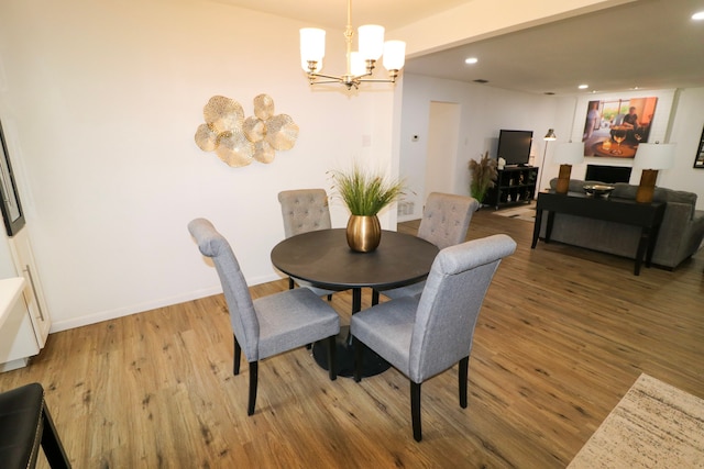 dining room featuring light hardwood / wood-style flooring and a notable chandelier