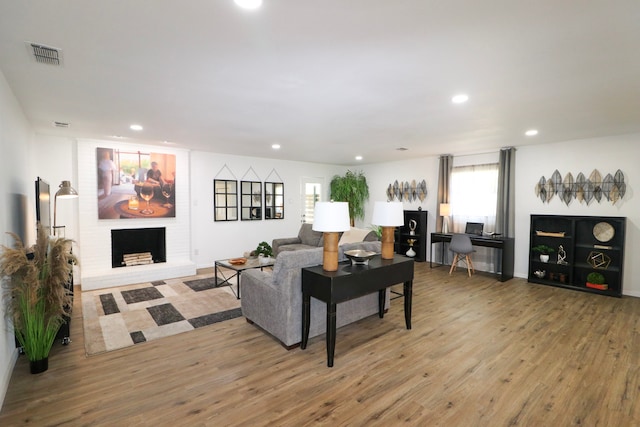 living room with a fireplace and hardwood / wood-style flooring