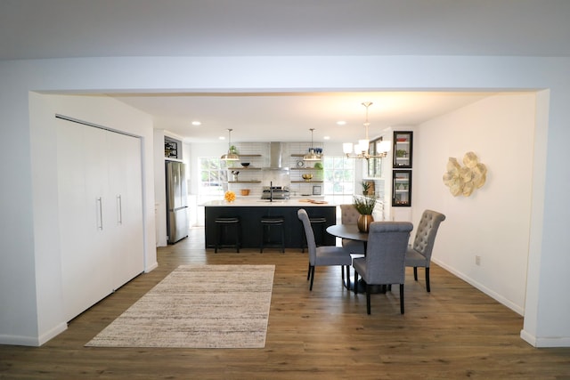 dining room with dark hardwood / wood-style flooring and a chandelier